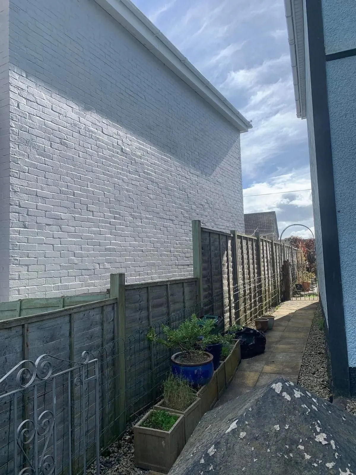 Freshly painted brick wall after preparation and masonry paint in Polzeath
